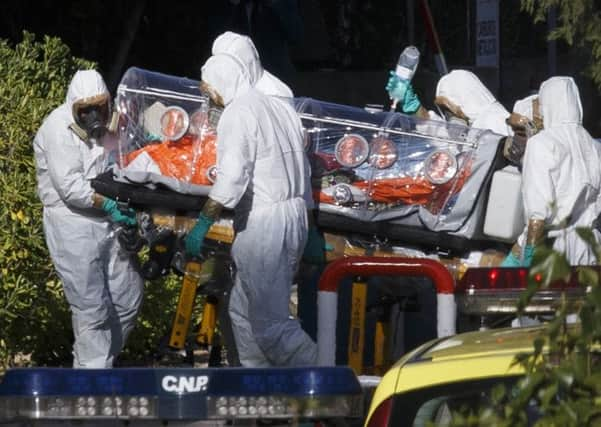 Health workers in Madrid wheel a stretcher carrying Spanish priest Miguel Pajares,75, who has tested positive for Ebola after working in Liberia. Picture: Reuters