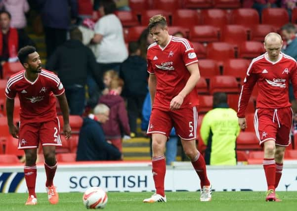 Aberdeens Ashton Taylor, left, and Willo Flood show their dejection during Sundays defeat. Picture:SNS