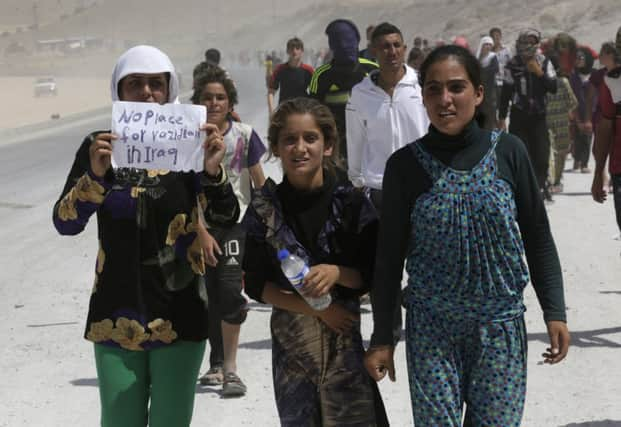 Displaced people from the minority Yazidi sect march in a demonstration at the Iraqi-Turkish border crossing. Picture: Reuters