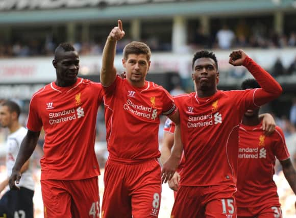 Liverpool debutant Mario Balotelli, left, and fellow striker Daniel Sturridge, right, congratulate captain Steven Gerrard. Picture: Getty