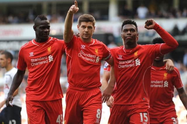 Liverpool debutant Mario Balotelli, left, and fellow striker Daniel Sturridge, right, congratulate captain Steven Gerrard. Picture: Getty