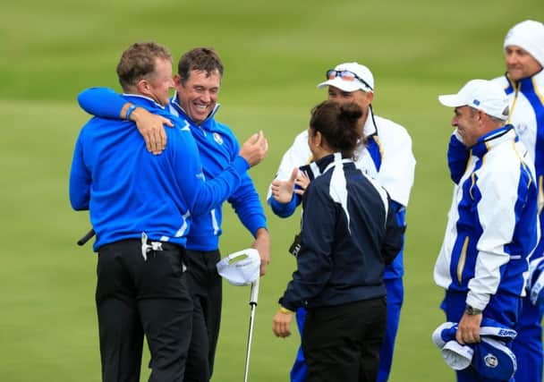 Lee Westwood embraces his foursomes partner Jamie Donaldson. Picture: PA