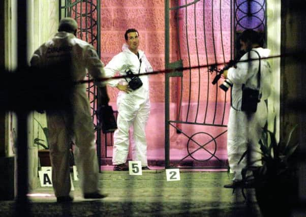 Police inspect the site where a Calabria councillor was shot and killed in Locri. Photograph: AP/Adriana Sapone