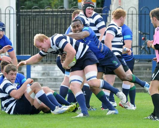 Heriots back rower Jason Hill is held by Boroughmuir winger Apenai Kororua. Picture: Lisa Ferguson