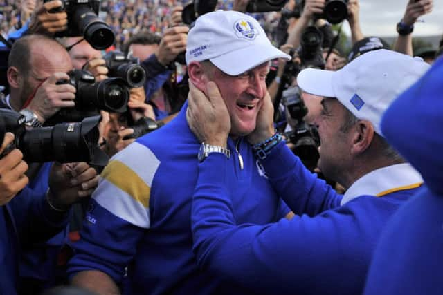 Paul McGinley of Ireland celebrates with Jamie Donaldson on the 15th green. Picture: Getty