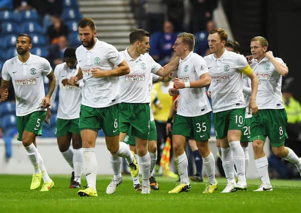 Jason Cummings (35) is mobbed by his team-mates as they celebrate his opener at Ibrox. Picture: SNS