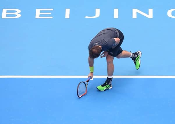 Whoops: Andy Murray smashes his racket in the match against Novak Djokovic at the China Open. Picture: Chris Hyde/Getty Images