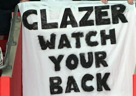 Manchester United fans show their displeasure at American Malcolm Glazer's takeover of the club,  during their English Premiership soccer match against Southampton played at St Mary's Stadium, Southampton, England. Sunday May 15 2005. (AP Photo/Paul Ellis) **NO INTERNET/MOBILE USEAGE WITHOUT FAPL LICENCE - SEE IPTC SPECIAL INSTRUCTIONS FIELD FOR DETAILS**