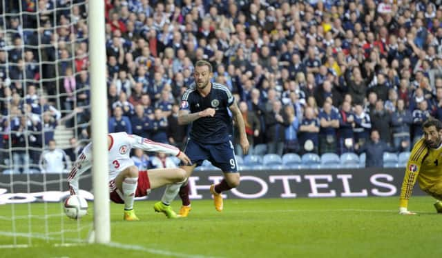 Steven Fletcher looks on as Shaun Maloneys shot strikes Akaki Khubutia of Georgia and spins into the net. Picture: Ian Rutherford