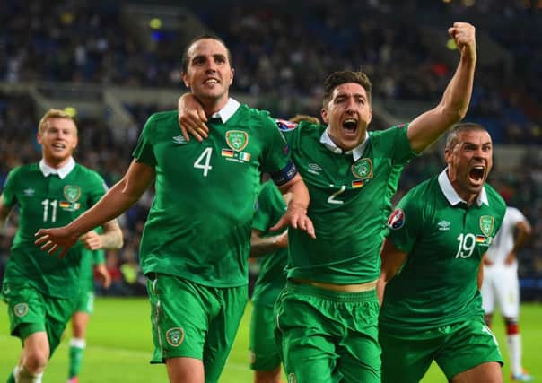 John OShea, left, celebrates his dramatic stoppagetime equaliser with teammates Stephen Ward and Jon Walters, right. Picture: Getty Images