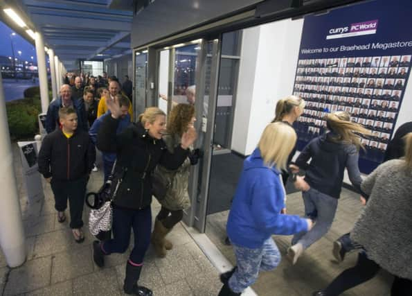 Shoppers entering Currys PC World at Braehead Shopping Centre on Black Friday. Picture: PA