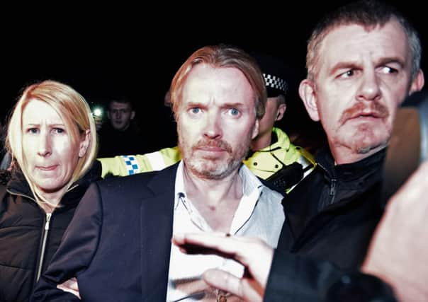 Former Rangers owner Craig Whyte is surrounded by police after being released on bail following a court appearance. Picture: Getty