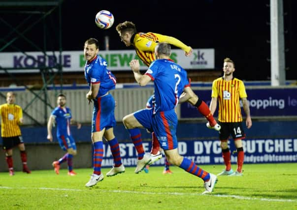 Partick Thistle's Gary Fraser (second from left) heads the ball into the net. Picture: SNS