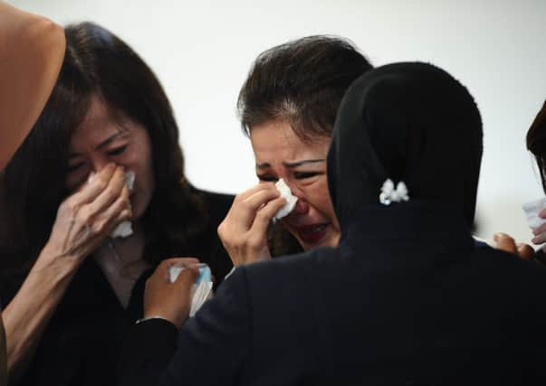 Grieving relatives of missing AirAsia flight QZ8501 passengers at the crisis centre of Juanda International Airport Surabaya. Picture: Getty