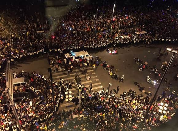 Police hold back the crowds as paramedics tend to the injured in Shanghais deadly New Years Eve stampede. Picture: Getty