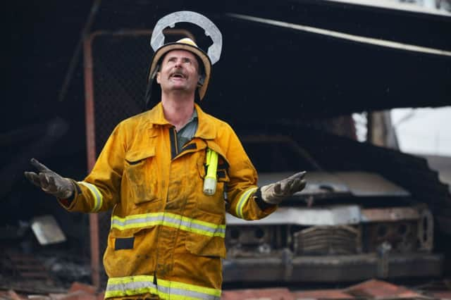 Rain starts to fall on a fire service volunteer in the Adelaide Hills. Picture: Brenton Edwards/AFP/Getty Images