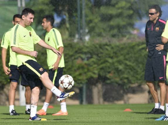 Barcelonas coach Luis Enrique watches Lionel Messi on the ball. Picture: Getty