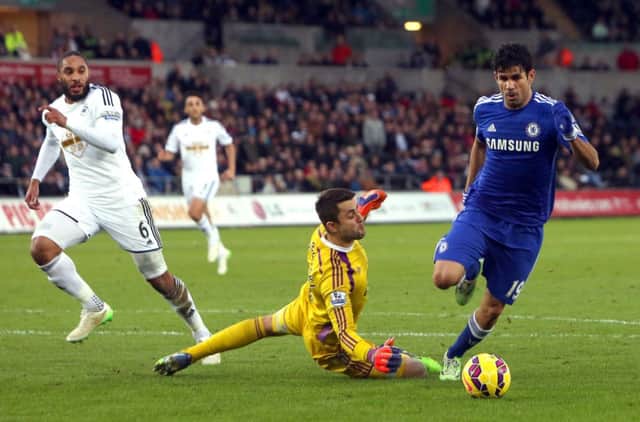 Its all too simple for Diego Costa as he rounds Lukasz Fabianski for goal number 3 after Federico Fernandezs error. Picture: Getty