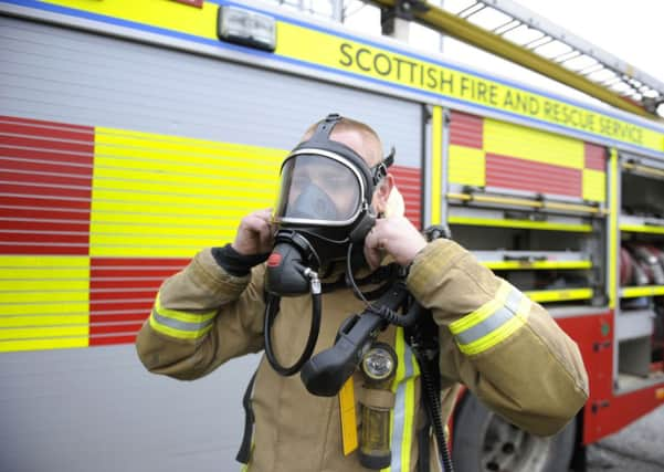 Fire fighters rescued one man while neighbours retrieved another with ladders. Picture: John Devlin