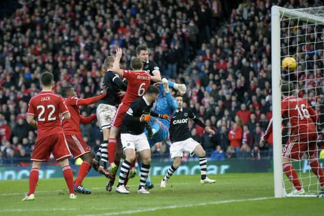 Dundee United defender Callum Morris climbs highest to head his side level on the hour mark. Picture: SNS