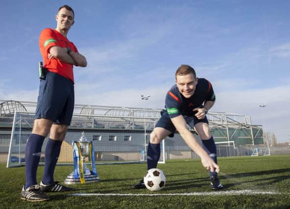 Referees Don Robertson (left) and John Beaton are on hand to demonstrate the use of Vanishing Spray. Picture: SNS