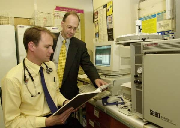 Doctors examine results of a test for a pill-based dementia treatment. Picture: TSPL