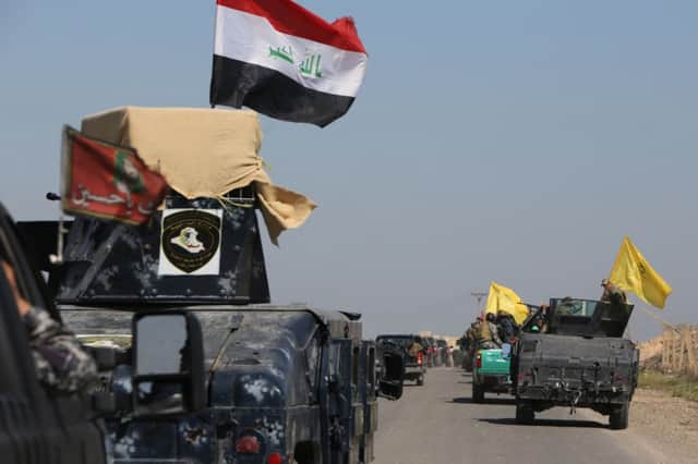 Some of the 30,000 members of the Iraqi security forces involved in the offensive to retake Tikrit head for the city. Picture: Getty