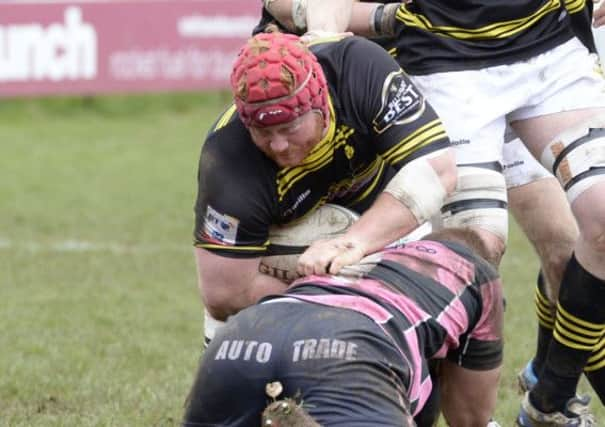 Melrose prop Euan McQuillan tries to burst through Andrew Dunlops tackle at Millbrae. Picture: SNS/SRU