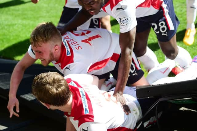 Falkirk goalscorer Craig sibbald (centre) celebrates with team-mates. Picture: SNS