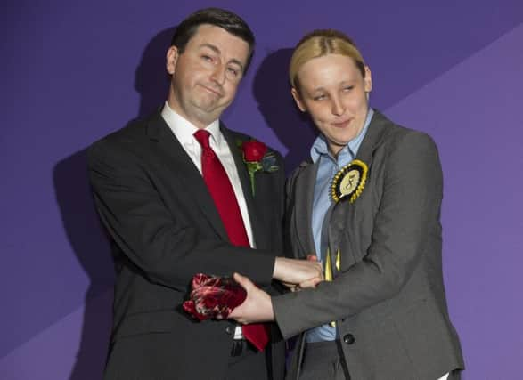 Labours Douglas Alexander shakes hands with the victor in his Paisley and Renfrewshire South seat, 20-year-old Mhairi Black. Picture: Lesley Martin