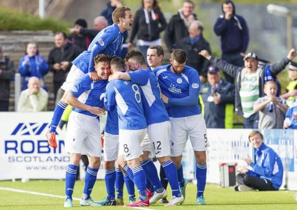 Queens players congratulate Derek Lyle, hidden, after equalising. Picture: SNS