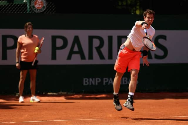 Coach Amélie Mauresmo supervises from the back of the court as Andy Murray serves during practice for the French Open at Roland Garros. Picture: Getty