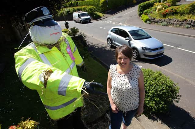 Pamela Johnston with the scarecrow. Picture: HeMedia