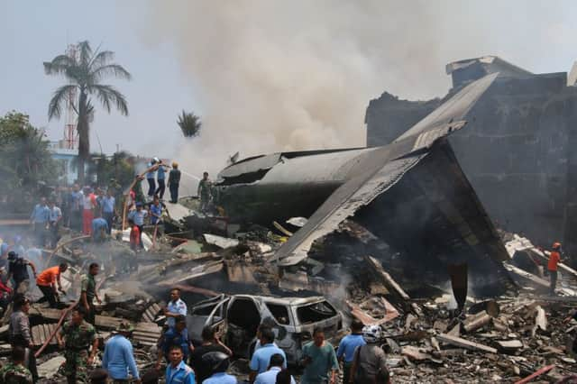 Rescue workers in Medan search for victims at the scene. Picture: AFP/Getty