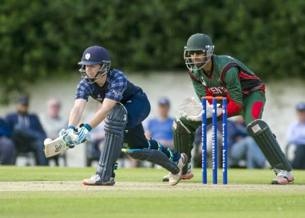 Scotland's Matthew Cross, left, sweeps the ball away. Picture: Donald MacLeod