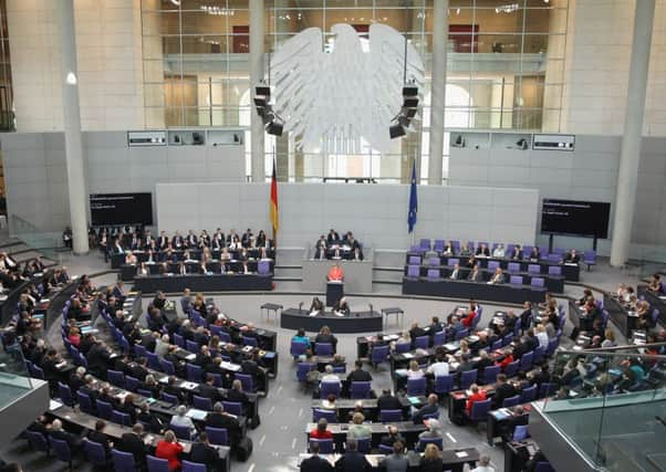 Angela Merkel speaks prior to a bailout vote in the German parliament yesterday. Picture: Getty