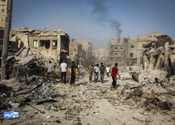 People look for survivors in the rubble after the warplane crashed in Ariha. Activist say it is not clear whether it was shot down or not. Picture: AP