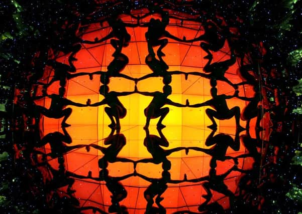 Forming an orderly pattern, Italian dance company Discoteque Machine performers in morphsuits use mirrors to create what they term the first human discoball at the Camera Obscura at the top of the Royal Mile in Edinburgh. Picture: Lisa Ferguson