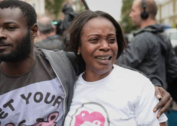 Members of staff show emotion as they leave for the final time as the Kids Company closes its building in Camberwell, London. Picture: PA