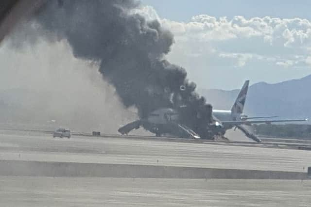 A passenger on another plane snapped this photo of the BA flight shrouded in smoke on the runway. Picture: AP