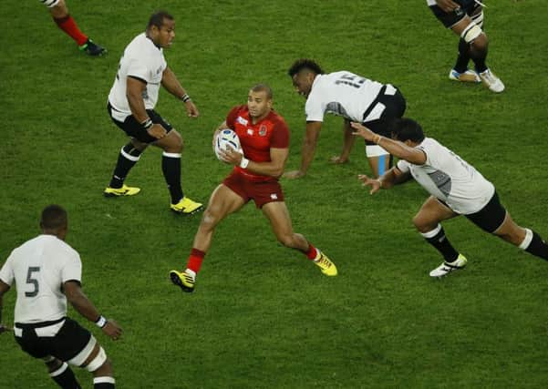 Englands Jonathan Joseph finds himself surrounded by a clutch of Fiji players during the opening match of the 2015 World Cup. Picture: AP