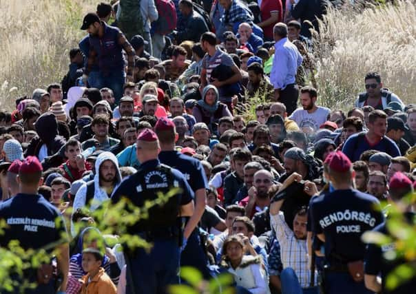 Migrants walk through the countryside after crossing the Hungarian-Croatian border near the Hungarian village of Zakany. Picture: AFP/Getty