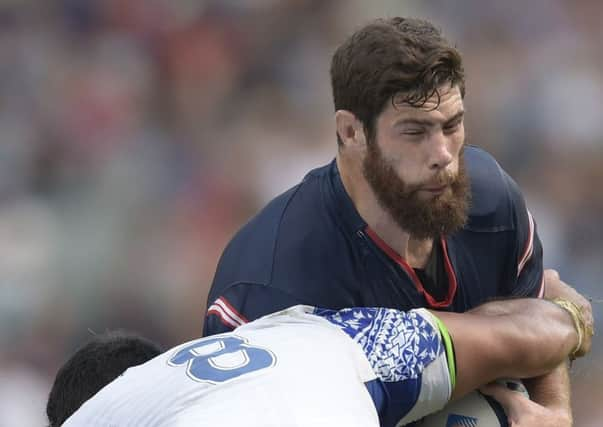 Greg Peterson takes on Samoa No 8 Ofisa Treviranus in their opening Pool B game. Picture: AFP/Getty