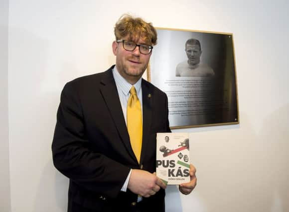 Author Gyorgy Szollosi with his book on Puskas and the plaque dedicated to the 1960 European Cup final at Hampden. Picture: SNS