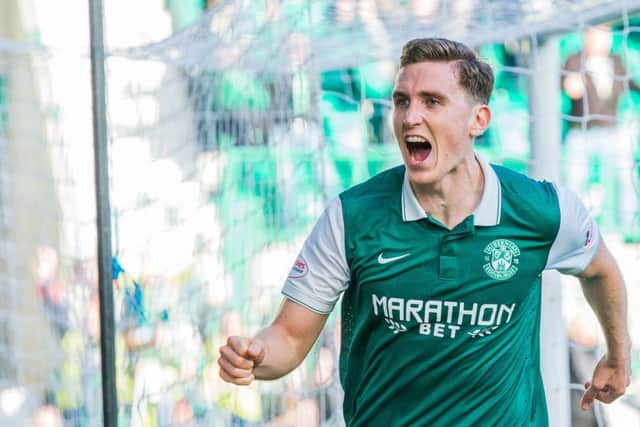 Paul Hanlon wheels away after powering a header past Wes Foderingham to hand Hibs victory over Rangers. Picture: Ian Georgeson