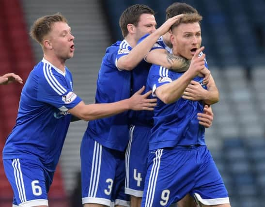 Rory McAllister, right, celebrates opening the scoring. Picture: SNS Group