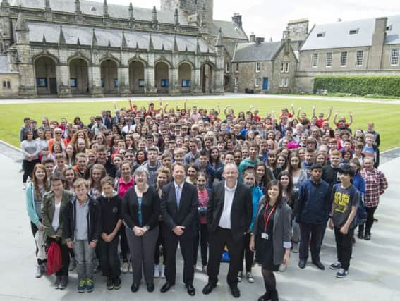 Kenneth Ferguson above with colleagues and schoolchildren. Picture: Alan Richardson