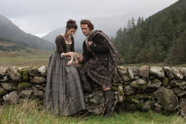 Caitriona Balfe and Sam Heughan playing Claire Randall and Jamie Fraser in Outlander