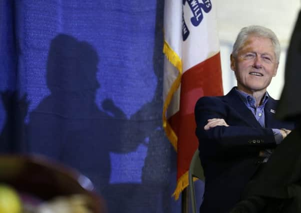 Former President Bill Clinton listens to his wife, Democratic presidential candidate Hillary Rodham Clinton speak in Ames, Iowa. Picture: AP