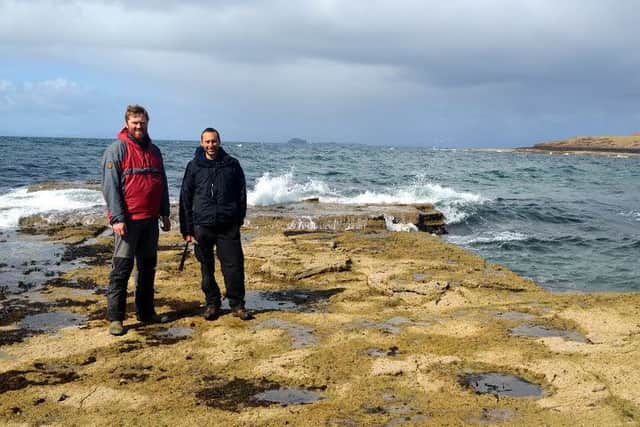 Dr Tom Challands and Dr Steve Brusatte pose by sauropod tracks on Skye. Picture: Mark Wilkinson